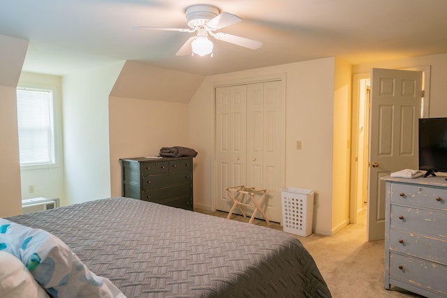 bedroom with ceiling fan, a closet, and light colored carpet