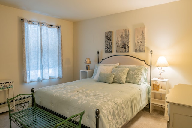 bedroom featuring baseboard heating and light colored carpet