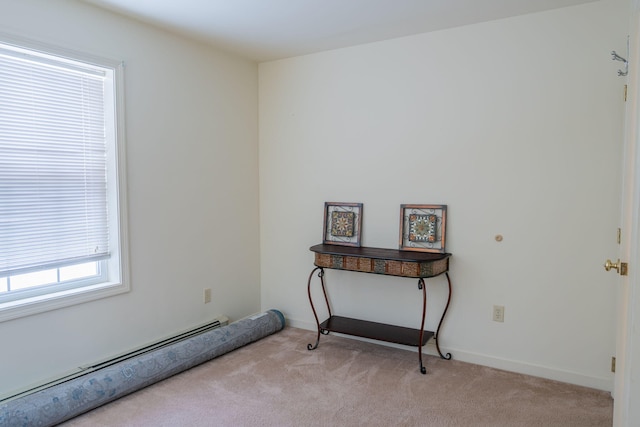 carpeted spare room featuring baseboard heating