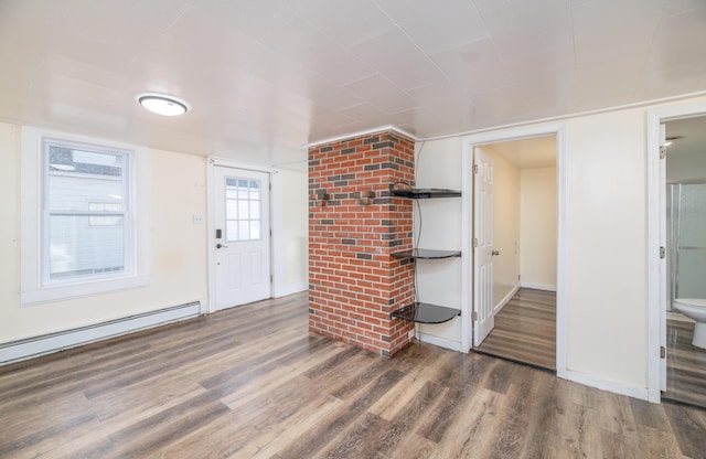 foyer with dark hardwood / wood-style floors and a baseboard heating unit