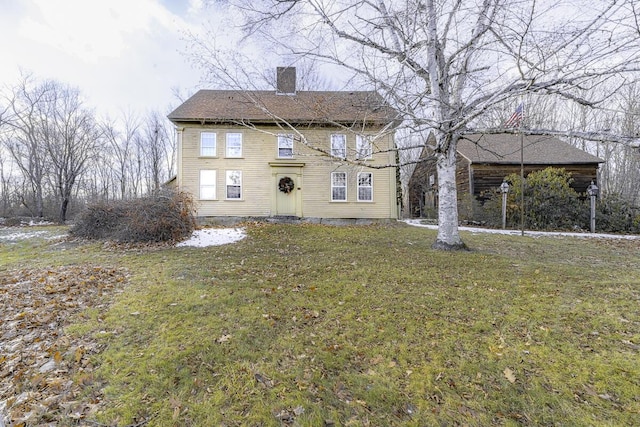 rear view of house featuring a yard