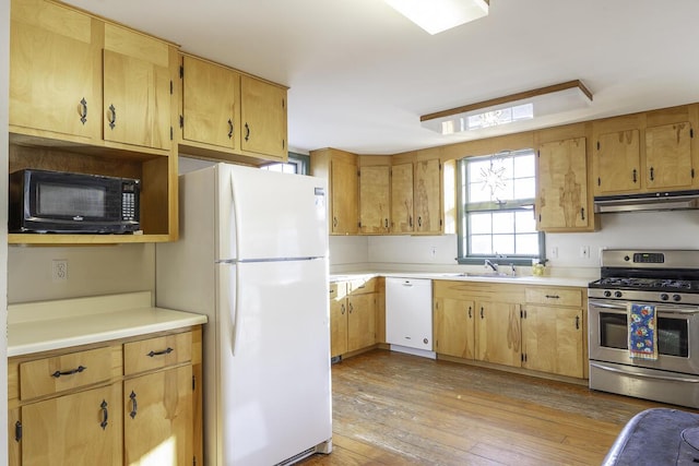 kitchen with light wood-type flooring, sink, and white appliances