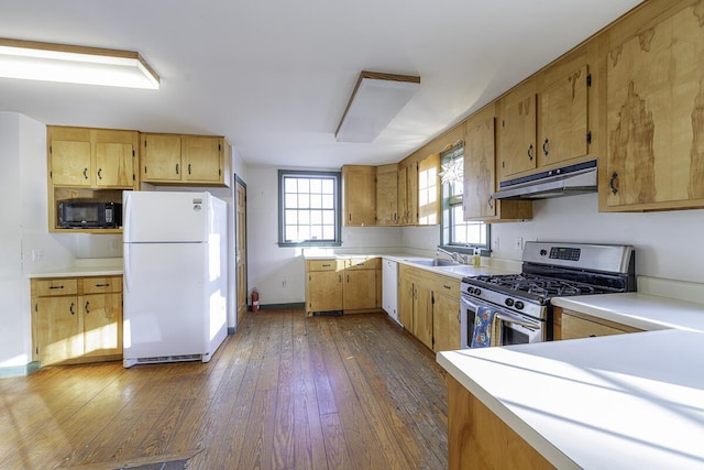 kitchen with sink, dark wood-type flooring, stainless steel range with gas cooktop, and white fridge