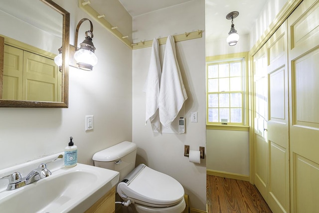 bathroom featuring hardwood / wood-style flooring, sink, and toilet