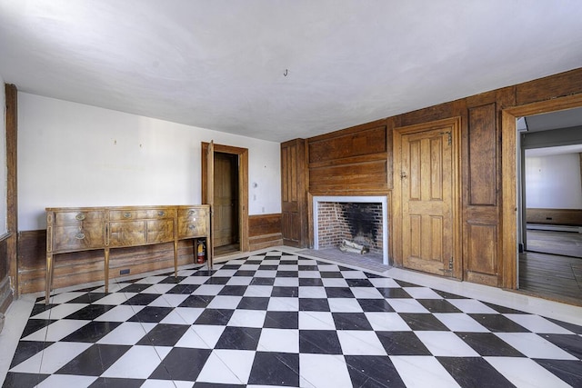 unfurnished living room with wood walls