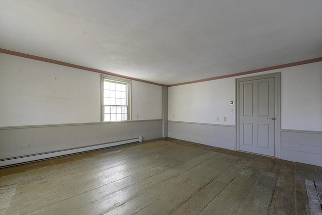 spare room with hardwood / wood-style floors, ornamental molding, and a baseboard radiator