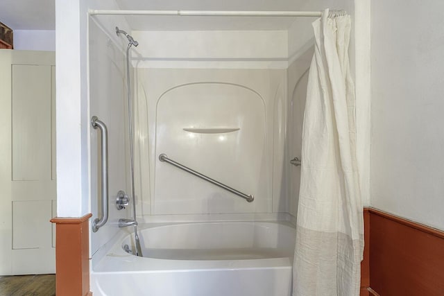 bathroom featuring hardwood / wood-style flooring and shower / tub combo