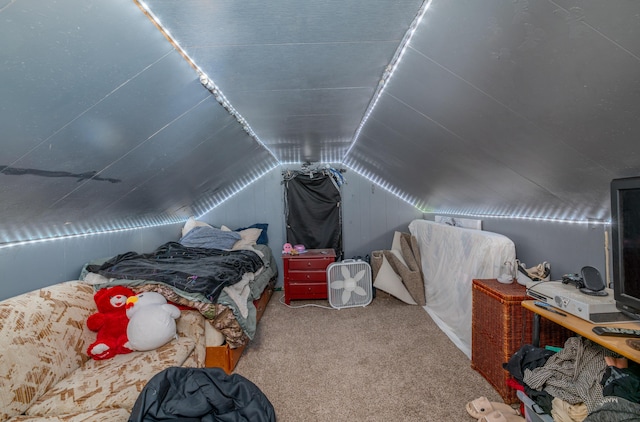 bedroom with carpet and lofted ceiling