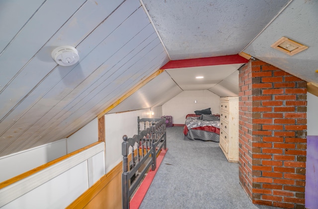 carpeted bedroom with a textured ceiling and lofted ceiling