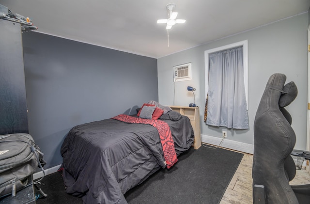 bedroom featuring wood-type flooring and a wall unit AC