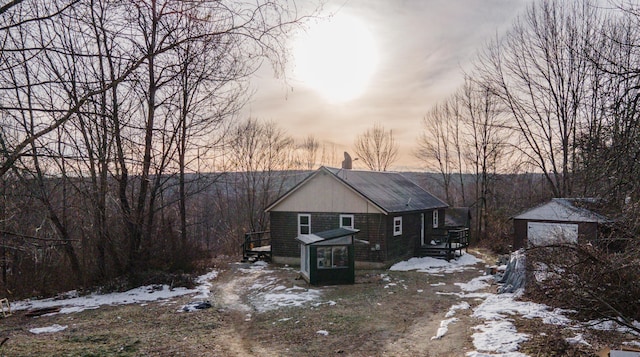 view of front of house featuring a garage and an outdoor structure