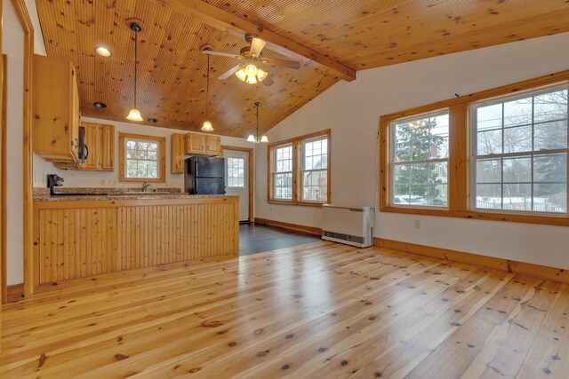 1696 N Rd, Parsonsfield, ME 04047 - kitchen with kitchen peninsula, light brown cabinetry, light wood-type flooring, black appliances, and decorative light fixtures