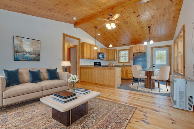 1696 N Rd, Parsonsfield, ME 04047 - living room with light wood-type flooring, ceiling fan with notable chandelier, high vaulted ceiling, wooden ceiling, and beamed ceiling