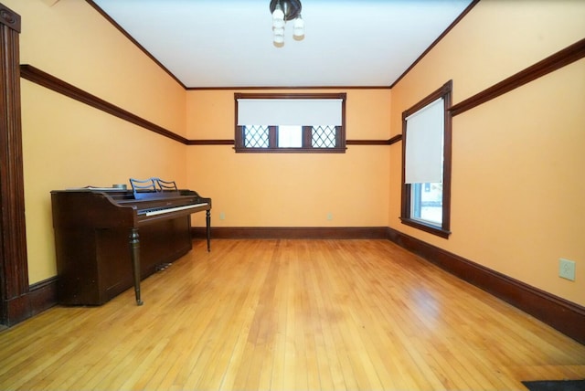 interior space with crown molding and light hardwood / wood-style floors