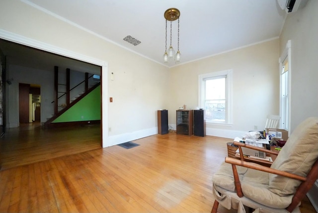 sitting room featuring light hardwood / wood-style floors and crown molding