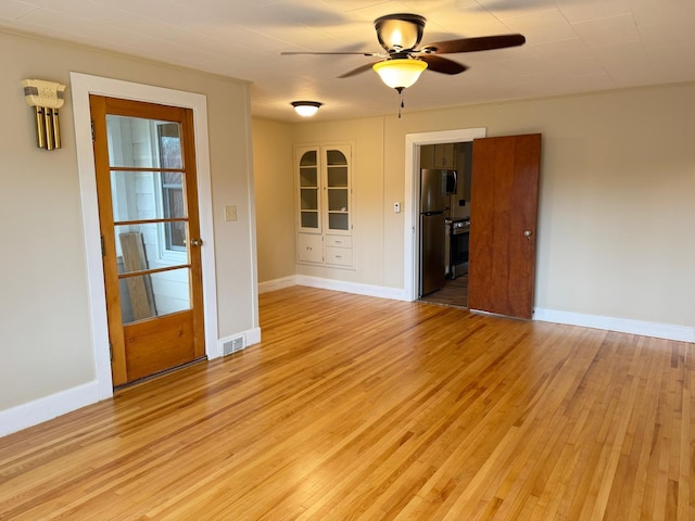 spare room with ceiling fan and light hardwood / wood-style flooring