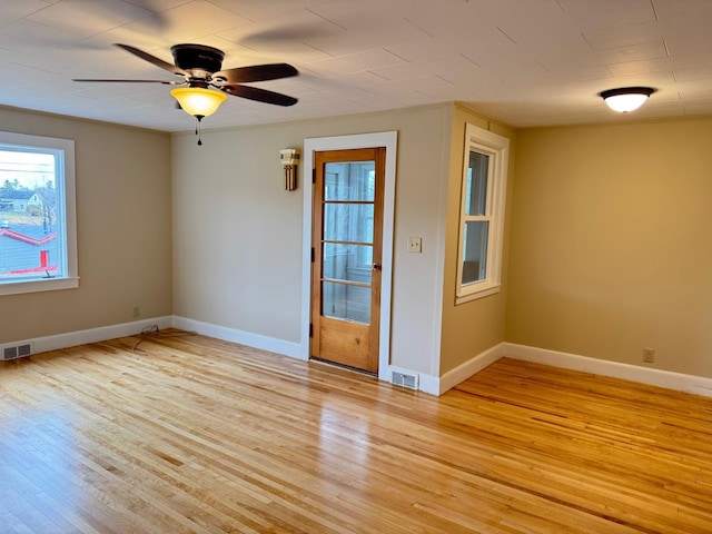 spare room with light hardwood / wood-style flooring and ceiling fan