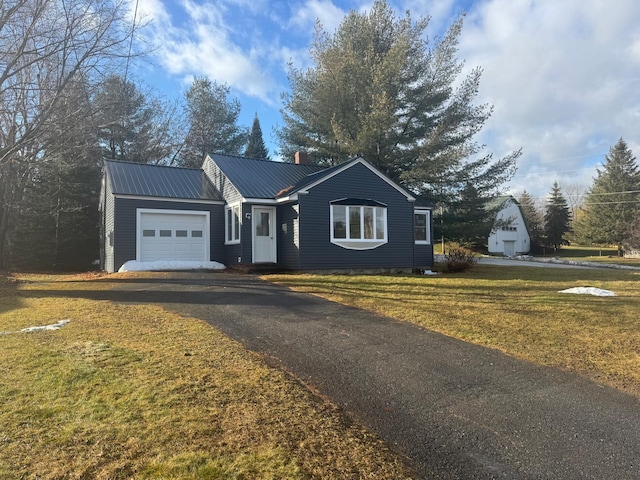 view of front of house featuring a garage and a front yard