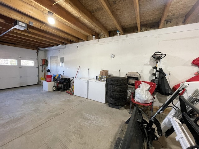 garage with washer and clothes dryer and a garage door opener