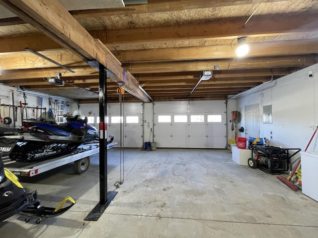 garage featuring electric panel and a garage door opener