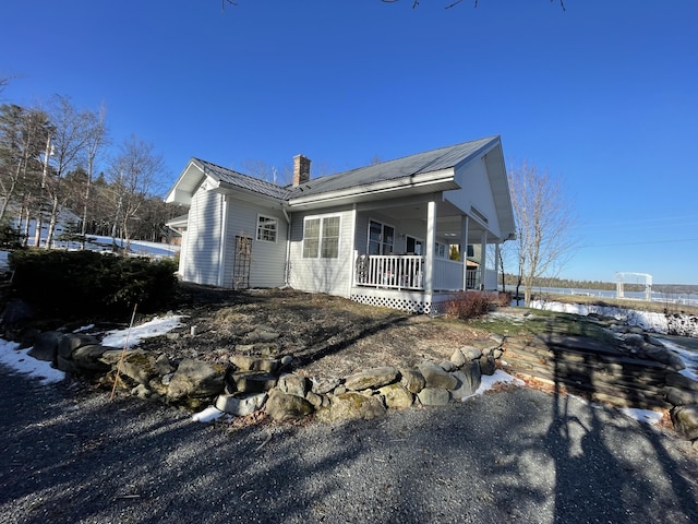 view of snowy exterior with a porch