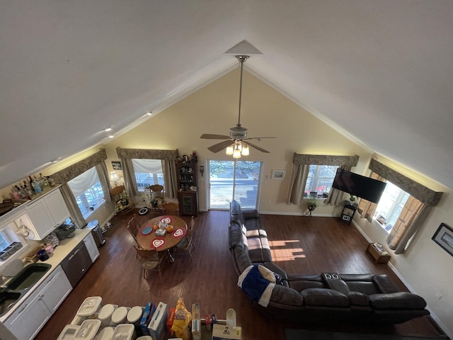 living room with ceiling fan, dark hardwood / wood-style flooring, crown molding, and high vaulted ceiling