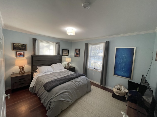 bedroom featuring dark hardwood / wood-style flooring, multiple windows, and crown molding