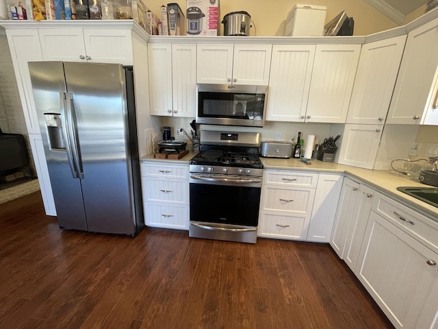 kitchen with white cabinetry, dark hardwood / wood-style flooring, and appliances with stainless steel finishes