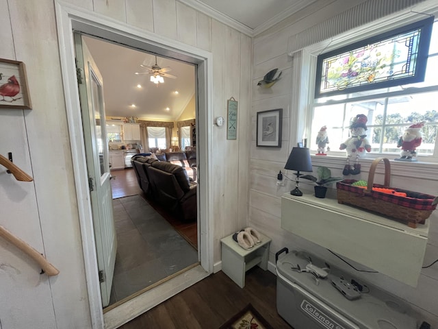 interior space featuring ceiling fan, crown molding, wood-type flooring, and vaulted ceiling