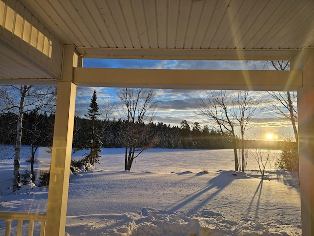 snowy yard with a water view