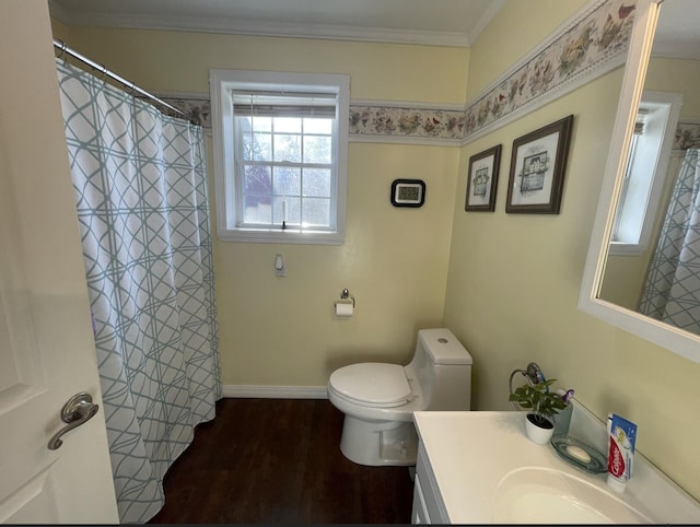 bathroom with toilet, vanity, wood-type flooring, and ornamental molding