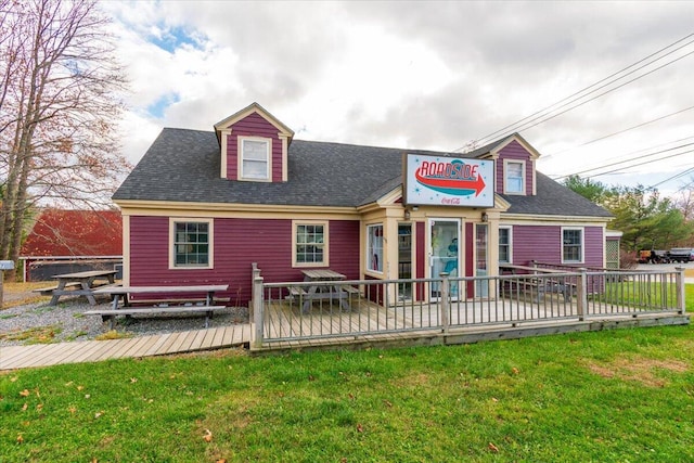 view of front of house with a front lawn and a deck