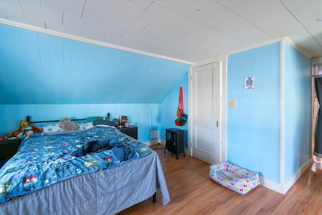 bedroom featuring hardwood / wood-style floors and lofted ceiling