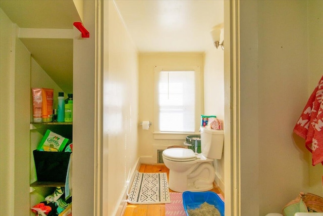 bathroom with hardwood / wood-style flooring and toilet