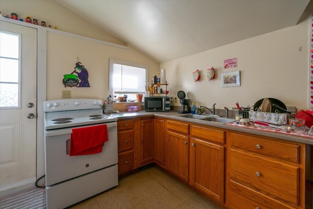 kitchen featuring white range with electric cooktop, lofted ceiling, and sink