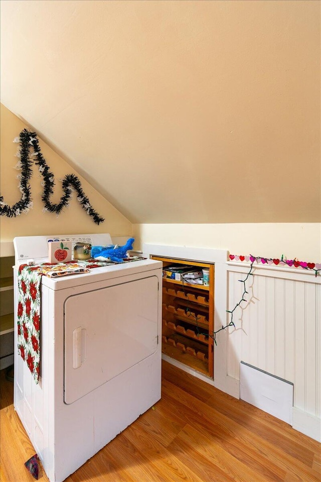 laundry room with washer / dryer and light hardwood / wood-style floors