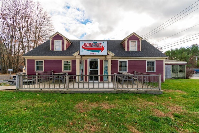 rear view of property with a lawn and a wooden deck