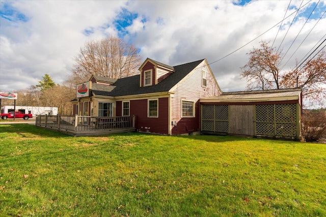 rear view of property with a yard and a wooden deck