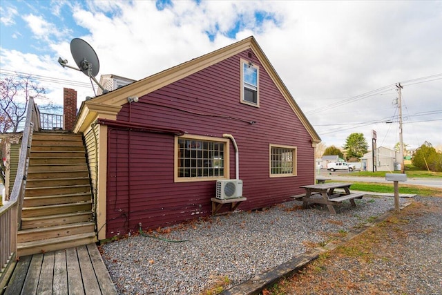 view of side of home with ac unit