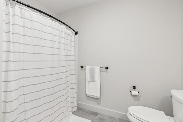 bathroom featuring tile patterned flooring and toilet