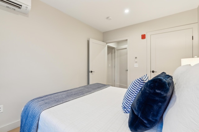 bedroom featuring a wall mounted air conditioner