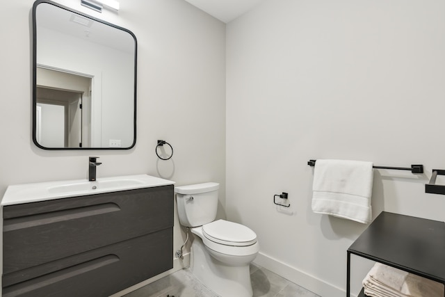 bathroom featuring tile patterned flooring, vanity, and toilet