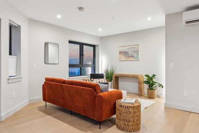 living room featuring a wall mounted air conditioner and light wood-type flooring