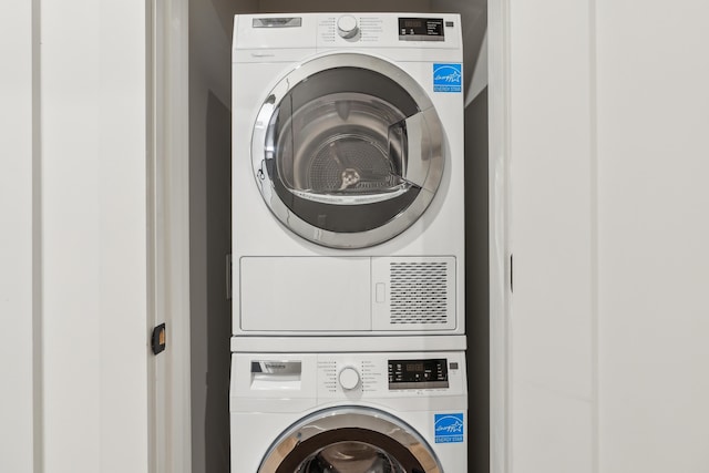 washroom with stacked washer / drying machine