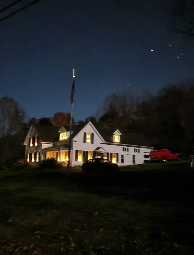 view of back house at twilight