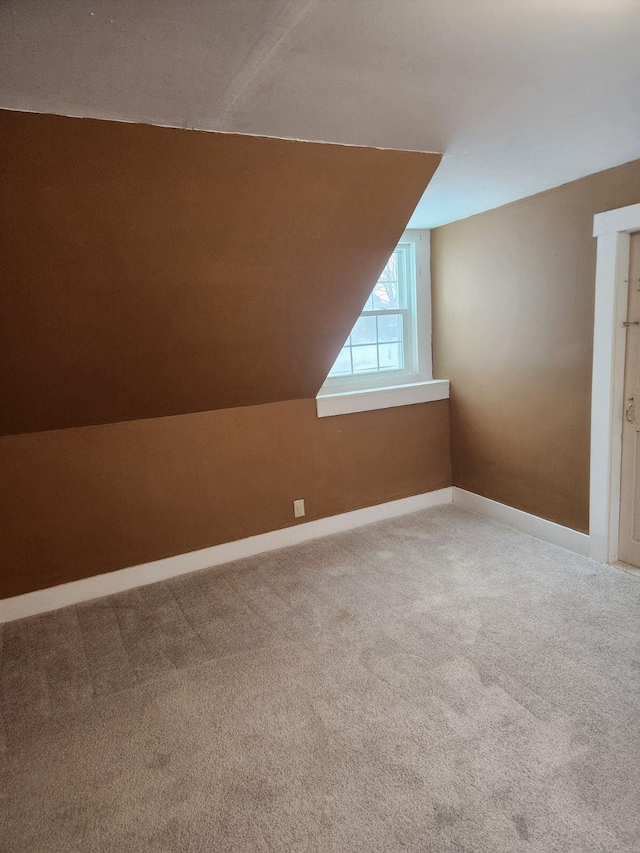 bonus room featuring carpet and lofted ceiling