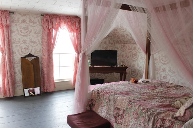 bedroom featuring hardwood / wood-style floors and multiple windows