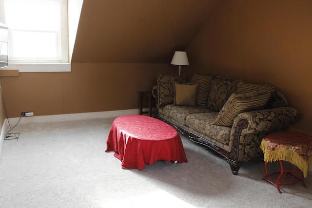 carpeted living room featuring vaulted ceiling