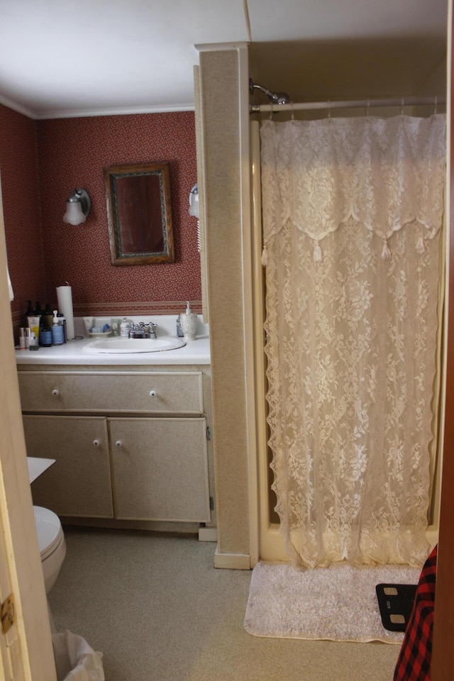 bathroom featuring a shower with curtain, toilet, crown molding, and vanity