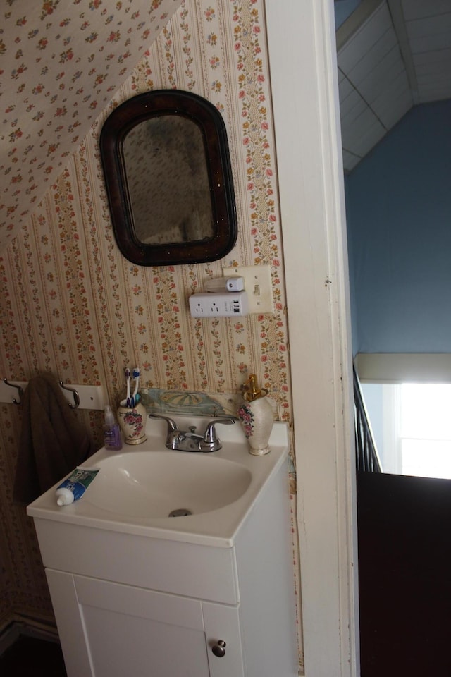 bathroom with vanity and vaulted ceiling